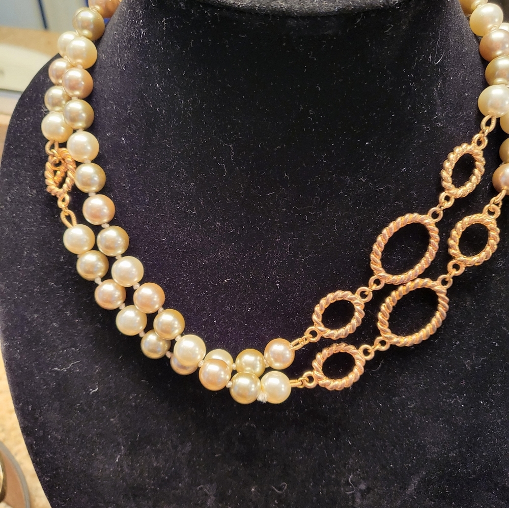 White and gray tone pearl long strand necklace with gold accents.